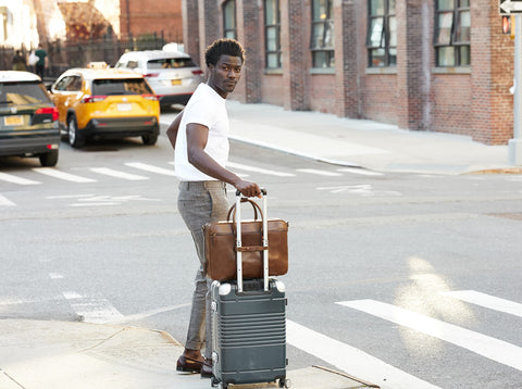 Counselor briefcase attached to luggage with luggage strap at a crosswalk