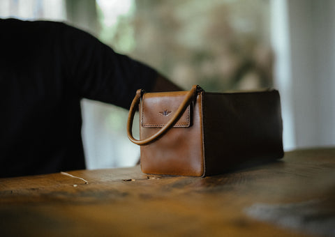 leather dopp kit on table