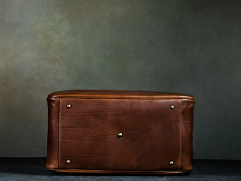 bottom of men's brown leather weekender bag