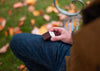 Model holding open AirPods case