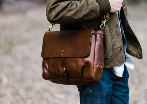 close up picture of brown leather messenger bag